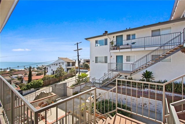 balcony with a water view and stairway