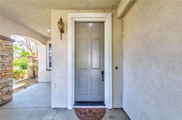 doorway to property with stucco siding