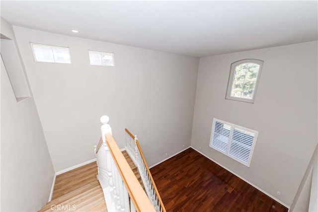 staircase featuring recessed lighting, wood finished floors, visible vents, and baseboards