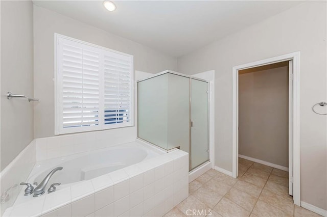 full bathroom with a garden tub, baseboards, a shower stall, and tile patterned floors