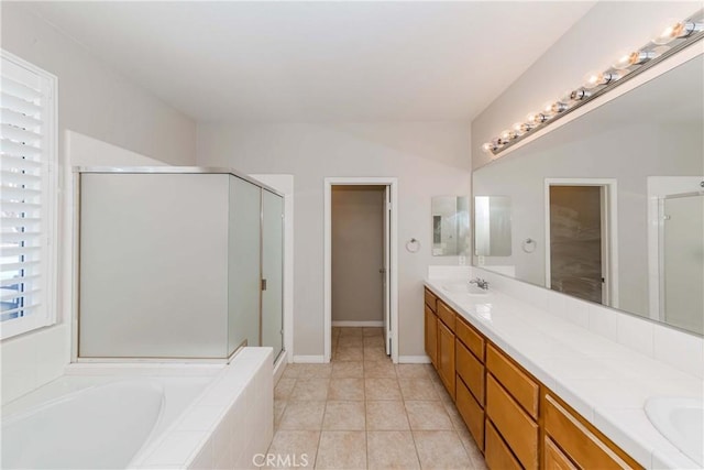 bathroom with a stall shower, a sink, a bath, and double vanity