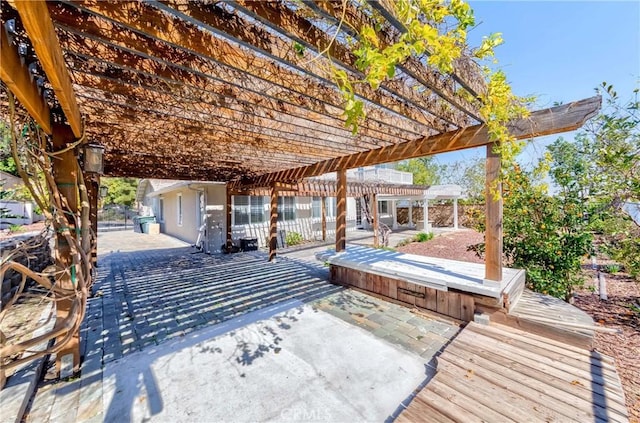 wooden deck with a patio and a pergola