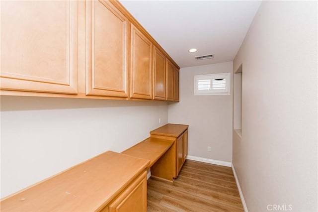 unfurnished office featuring recessed lighting, visible vents, light wood-style flooring, built in study area, and baseboards