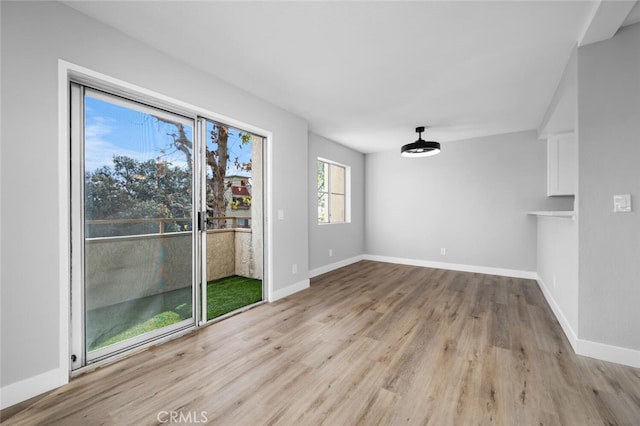 interior space with baseboards and wood finished floors