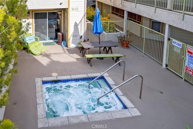 view of pool featuring a patio area and a community hot tub