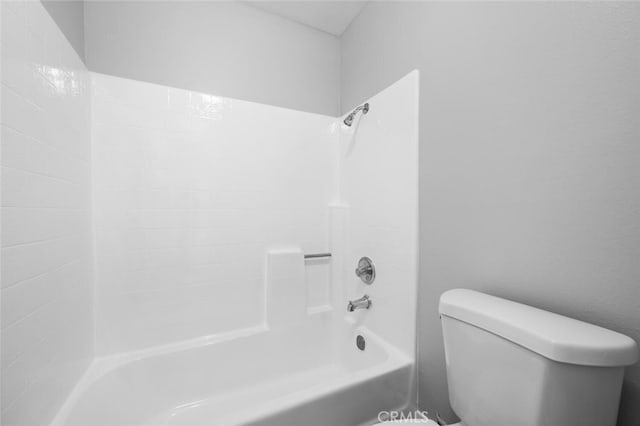 bathroom featuring shower / bath combination and toilet