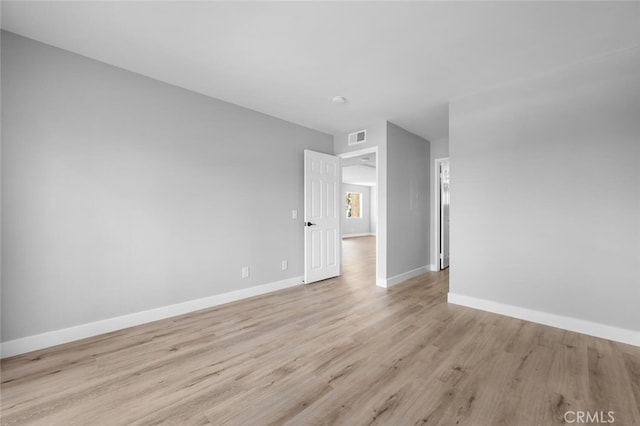 spare room with visible vents, baseboards, and light wood-style flooring