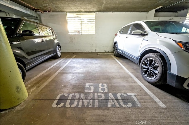 parking garage featuring concrete block wall