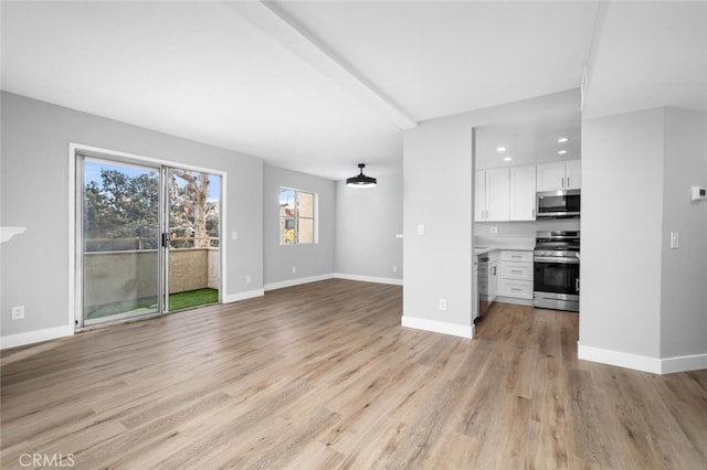 unfurnished living room featuring light wood-style flooring and baseboards