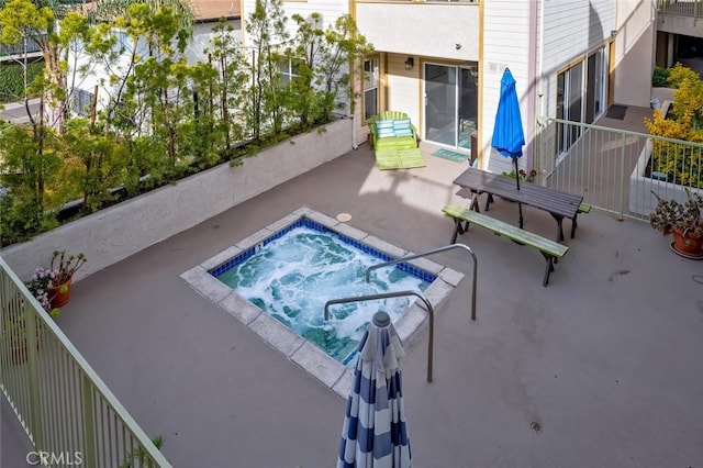 view of swimming pool featuring a patio and an in ground hot tub