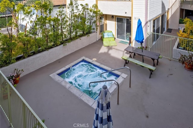 view of pool with a patio and an in ground hot tub