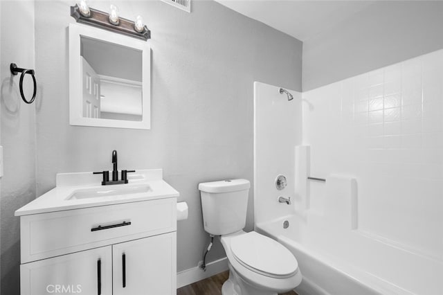 full bath with bathtub / shower combination, toilet, vanity, wood finished floors, and baseboards