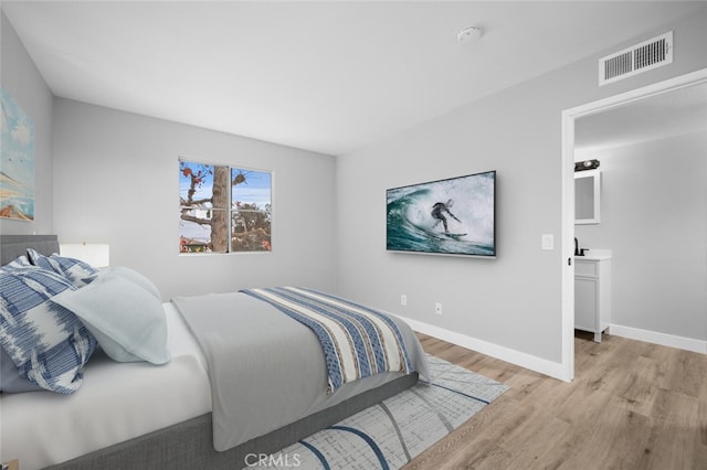 bedroom featuring light wood-style flooring, baseboards, and visible vents