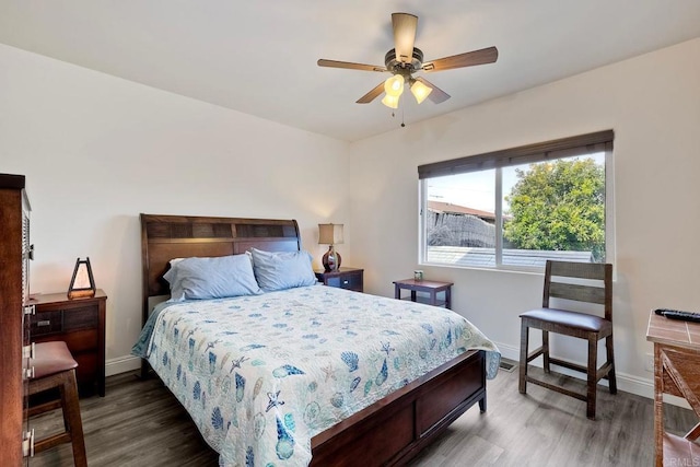 bedroom featuring a ceiling fan, baseboards, and wood finished floors