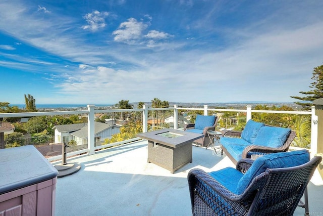 view of patio with an outdoor living space with a fire pit