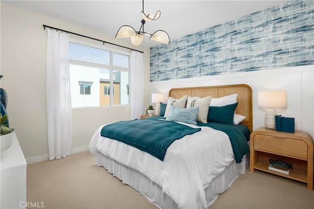 bedroom featuring carpet floors, wallpapered walls, baseboards, and an inviting chandelier