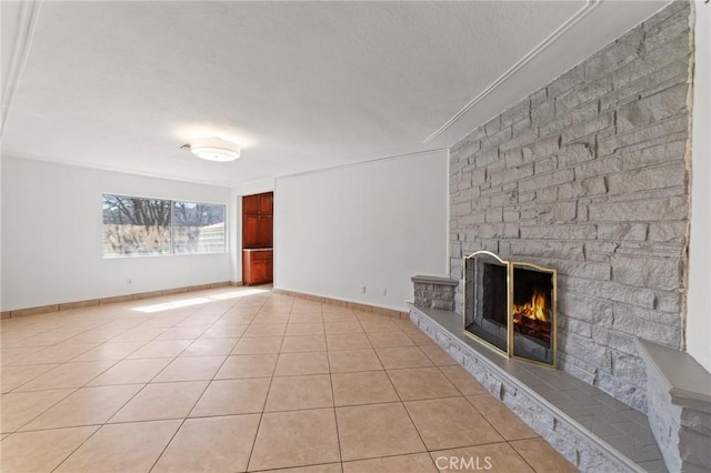 unfurnished living room with light tile patterned floors, a fireplace, and baseboards