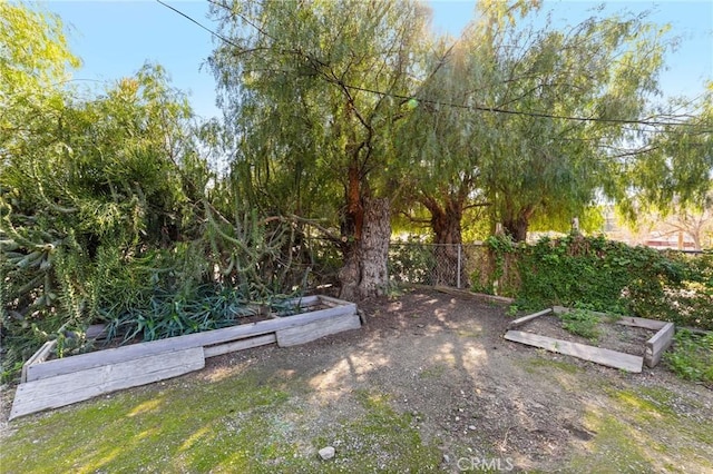 view of yard with a vegetable garden and fence