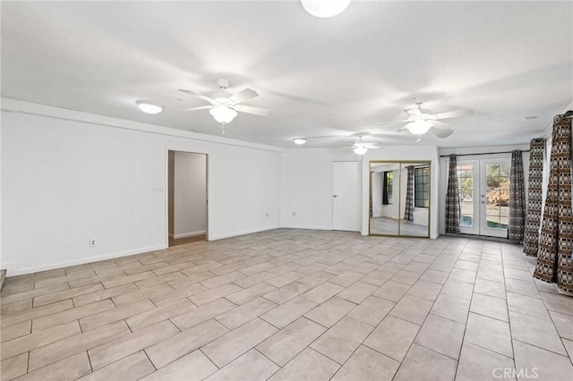 unfurnished room featuring french doors, baseboards, and a ceiling fan