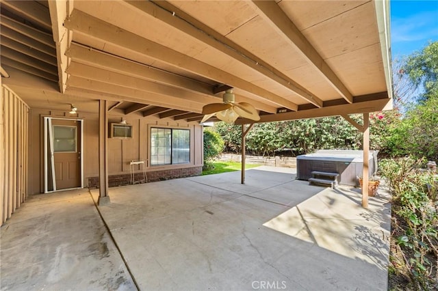 view of patio with a hot tub and a ceiling fan