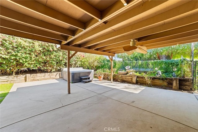 view of patio with a ceiling fan and a hot tub