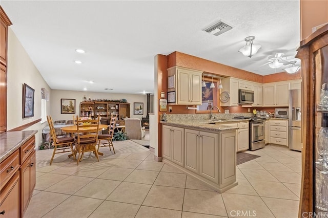 kitchen with visible vents, ceiling fan, light tile patterned floors, stainless steel appliances, and a sink