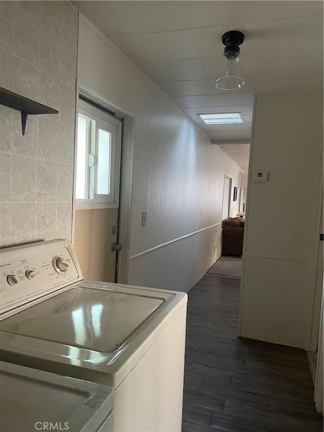 laundry area featuring dark wood-style floors, laundry area, and washer / dryer