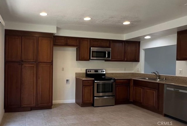 25885 Trabuco Rd Unit 271, Lake Forest, CA 92630 - kitchen featuring appliances with stainless steel finishes, light tile patterned floors, and recessed lighting