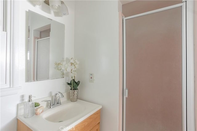 full bathroom featuring a stall shower and vanity