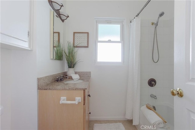 bathroom with shower / tub combo, vanity, and baseboards