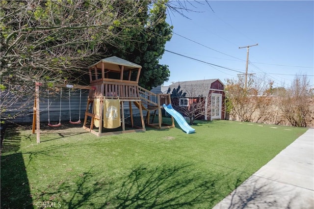 view of play area with a lawn and an outdoor structure