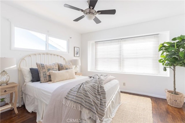 bedroom featuring ceiling fan, baseboards, and wood finished floors