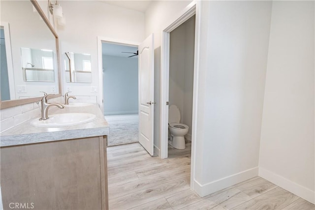 33112 Haddock St, Winchester, CA 92596 - bathroom featuring a sink, baseboards, toilet, and double vanity