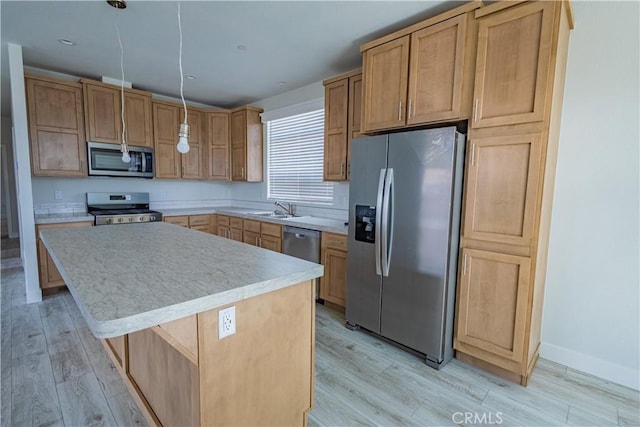 33112 Haddock St, Winchester, CA 92596 - kitchen featuring light wood-style floors, a sink, appliances with stainless steel finishes, and light countertops