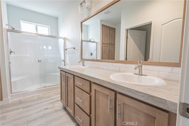 33112 Haddock St, Winchester, CA 92596 - full bath featuring double vanity, a sink, backsplash, and a shower stall