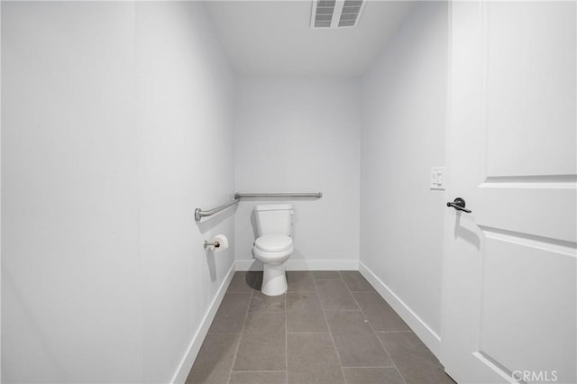 bathroom with toilet, tile patterned flooring, visible vents, and baseboards