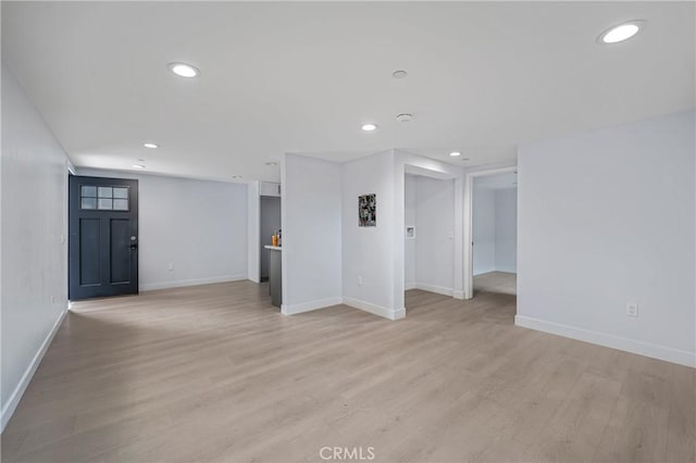 spare room with light wood-style flooring, baseboards, and recessed lighting