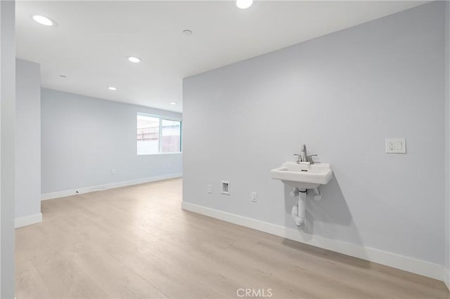 bathroom with recessed lighting, wood finished floors, and baseboards