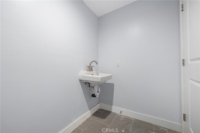 bathroom with baseboards and a sink