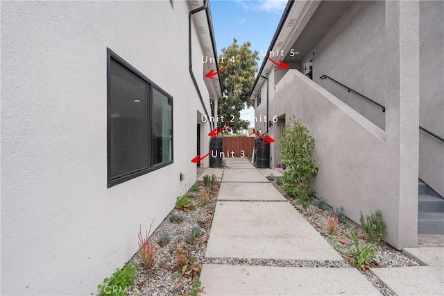 view of property exterior featuring fence and stucco siding