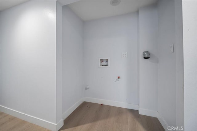 clothes washing area featuring laundry area, baseboards, hookup for a gas dryer, wood finished floors, and washer hookup