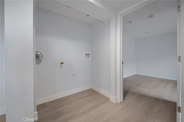 laundry area featuring washer hookup, laundry area, light wood-style flooring, and baseboards