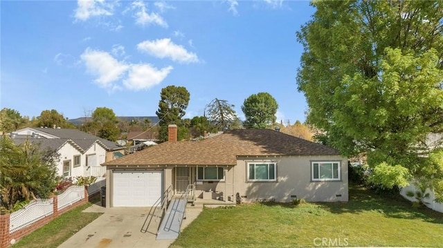 back of property featuring concrete driveway, a lawn, an attached garage, crawl space, and fence