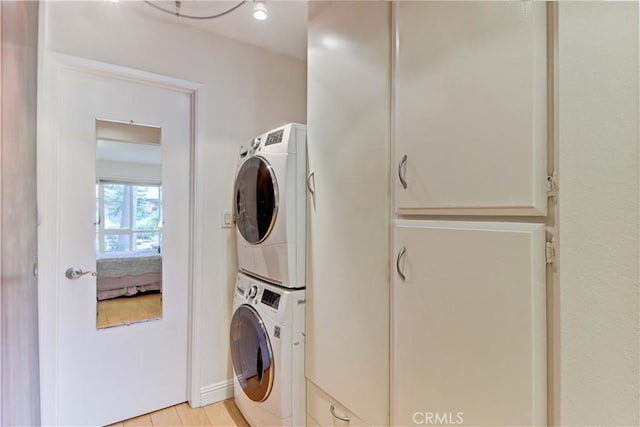 laundry room featuring stacked washing maching and dryer