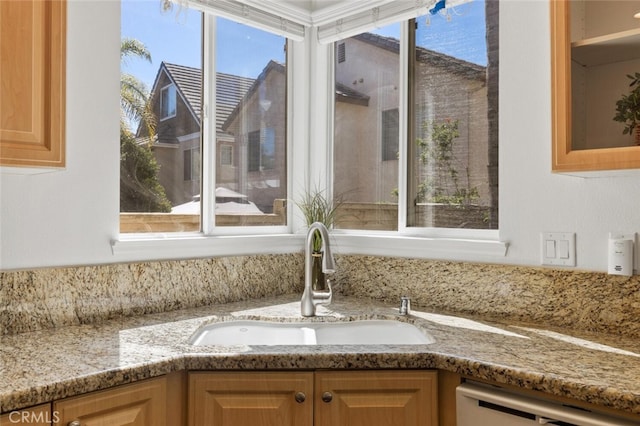27139 Saddlepeak Trl, Valencia, CA 91354 - details featuring a sink, glass insert cabinets, light stone counters, and dishwashing machine