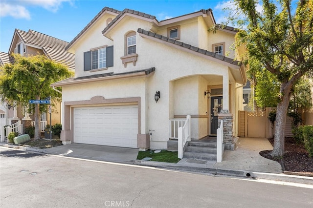 27139 Saddlepeak Trl, Valencia, CA 91354 - mediterranean / spanish home featuring concrete driveway, an attached garage, a tile roof, and stucco siding