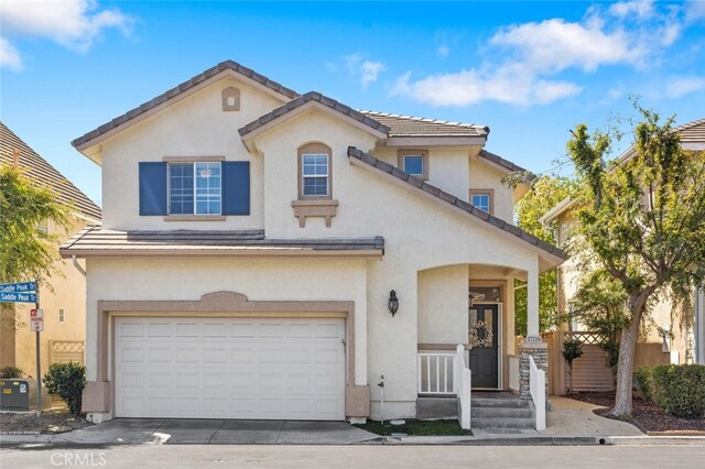 27139 Saddlepeak Trl, Valencia, CA 91354 - mediterranean / spanish house with concrete driveway, a tile roof, a garage, and stucco siding