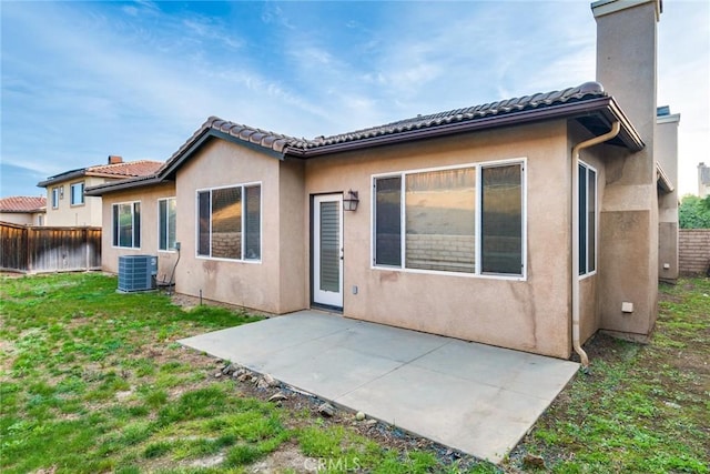 back of property featuring a patio, a chimney, stucco siding, central AC, and fence