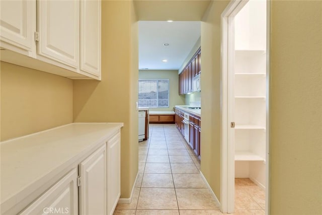 hallway featuring light tile patterned floors and recessed lighting