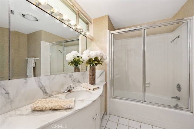 full bath featuring tile patterned floors, combined bath / shower with glass door, vanity, and tasteful backsplash